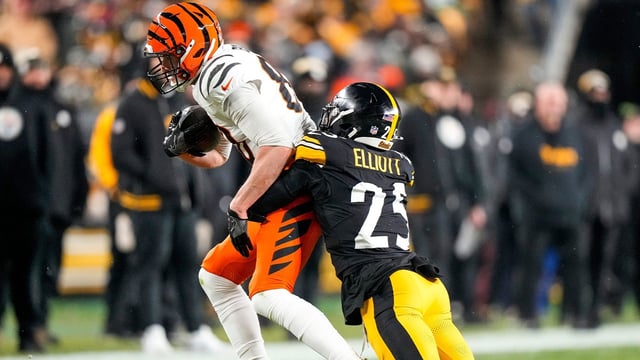 Cincinnati Bengals tight end Mike Gesicki (88) catches a pass under coverage from Pittsburgh Steelers safety DeShon Elliott (25) in the first quarter of the NFL Week 18 game between the Pittsburgh Steelers and the Cincinnati Bengals at Acrisure Stadium in Pittsburgh on Saturday, Jan. 4, 2025.