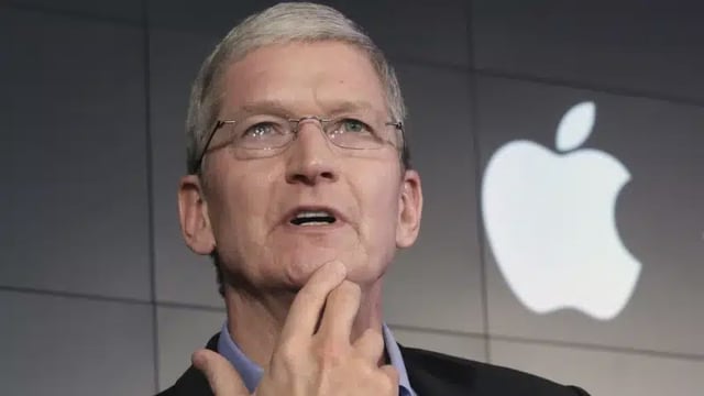 Apple CEO Tim Cook speaking with Apple logo in the background.