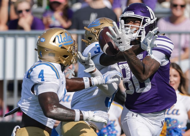 Hayden Eligon II  of the Northwestern Wildcats reaches to catch the ball against Robert Stafford III  of the UCLA Bruins during the first half in the NCAA football game between UCLA and Northwestern Wildcats at Martin Stadium on September 27, 2025 in Evanston, Illinois. (Photo by Michael Hickey/Getty Images)