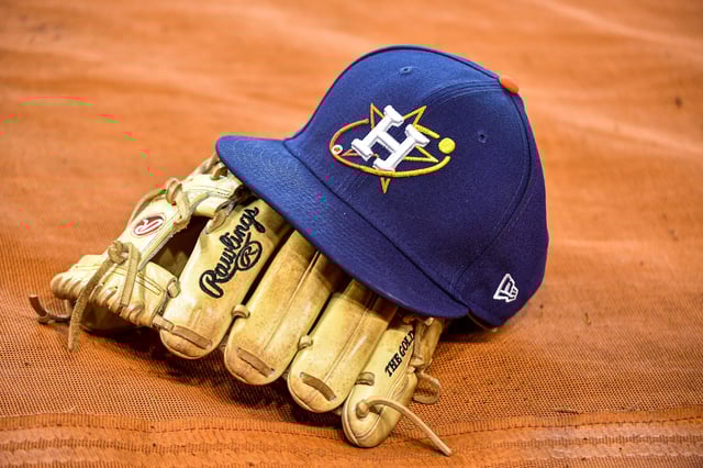 HOUSTON, TEXAS - JULY 05: Detail photo of a Houston Astros game hat and glove during batting practice at Minute Maid Park on July 05, 2022 in Houston, Texas. The Astros announced that former relief pitcher Ronny Garcia passed away.