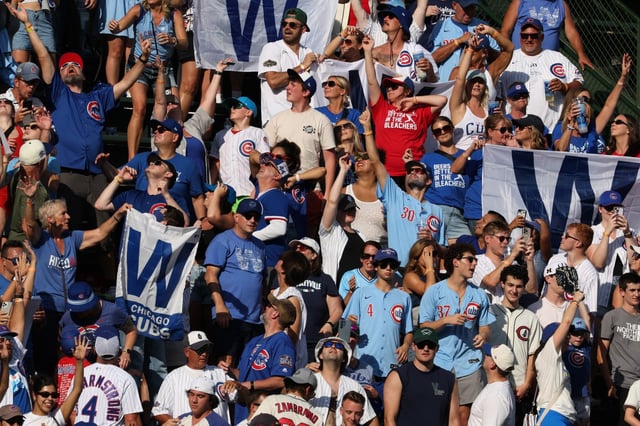 Cubs fans celebrate a 7-3 win over the Cardinals on Saturday, Sept. 27, 2025, at Wrigley Field. (John J. Kim/Chicago Tribune)