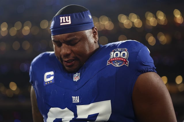 Dexter Lawrence II #97 of the New York Giants stands on the sidelines during the national anthem prior to an NFL game against the Cincinnati Bengals at MetLife Stadium on October 13, 2024 in East Rutherford, New Jersey.