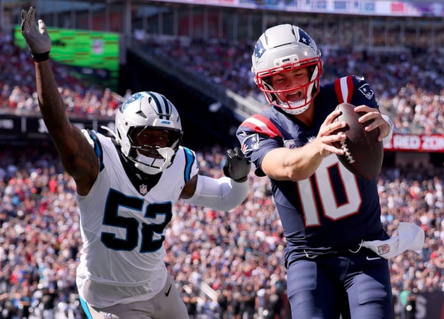 Foxboro, MA - New England Patriots quarterback Drake Maye scores  defended by Carolina Panthers' DJ Johnson during the second quarter of the game at Gillette Stadium. (Nancy Lane/Boston Herald)