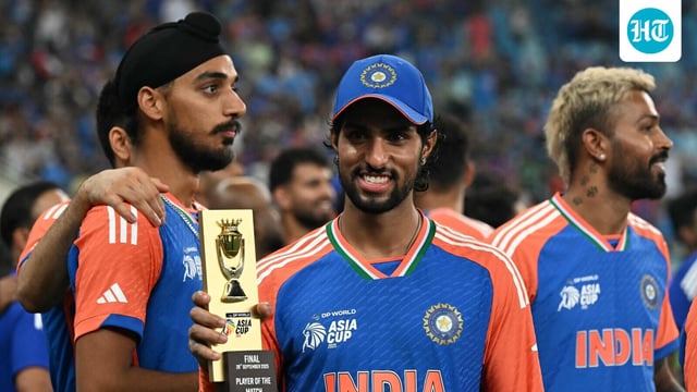 India's Tilak Varma holds up his man of the match trophy during the presentation ceremony at the end of the Asia Cup 2025 Twenty20 international cricket final match between India and Pakistan