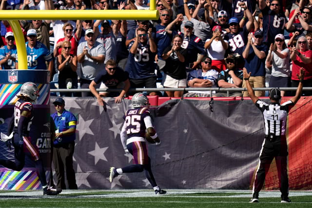 Patriots' Marcus Jones celebrates after his punt return touchdown against the Panthers.