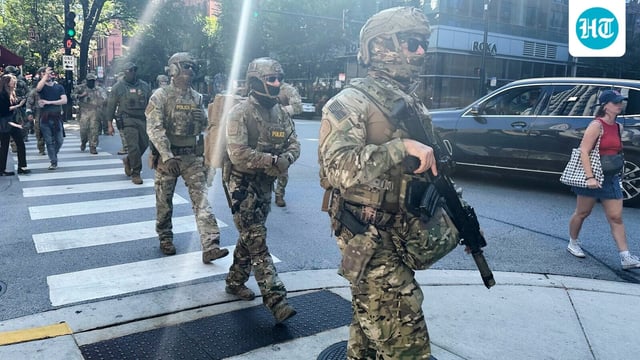 Federal agents patrol downtown Chicago, Sunday, Sept. 28, 2025.