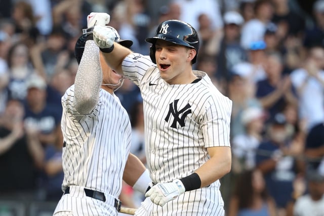 New York Yankees' Aaron Judge, left, and Ben Rice, right, react after Rice hit a home run during the eighth inning of a baseball game against the Baltimore Orioles, Sunday, Sept. 28, 2025, in New York. (AP Photo/Pamela Smith)
