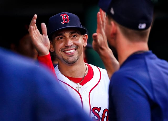 Red Sox starting pitcher Jose De Leon receives high-fives in the dugout Sunday.