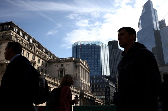 People walk outside the Bank of England in the City of London financial district in London, Britain May 11, 2023. REUTERS/Henry Nicholls/File Photo