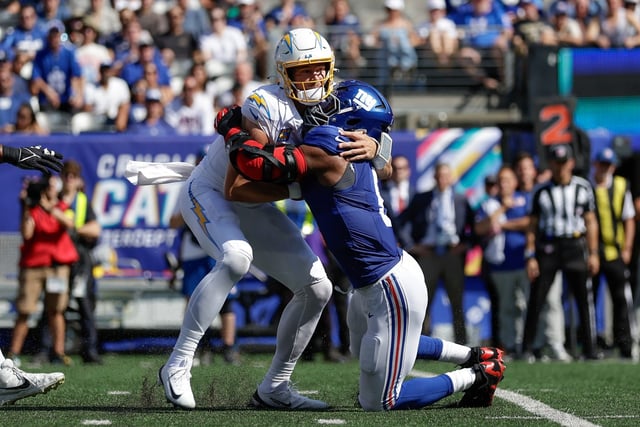 New York Giants linebacker Kayvon Thibodeaux (5) sacks Los Angeles Chargers quarterback Justin Herbert (10) during the first quarter of an NFL football game, Sunday, Sept. 28, 2025, in East Rutherford, N.J. (AP Photo/Adam Hunger)