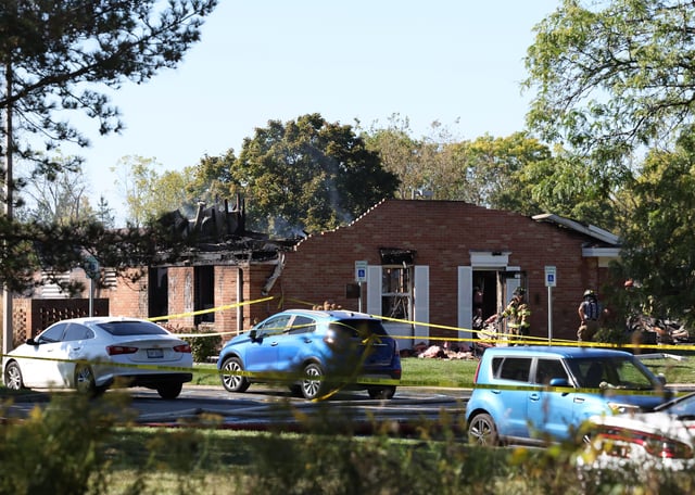 Fire and law enforcement officers stand outside the Church of Jesus Christ of Latter-day Saints, Sunday, Sept. 28, 2025 in Grand Blanc, Mich. (AP Photo/Carlos Osorio)