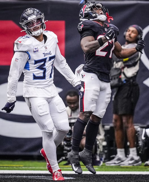 Houston Texans running back Woody Marks (27) celebrates his 18-yard touchdown run against the Tennessee Titans during the second half of an NFL football game at NRG Stadium in Houston, Sunday, Sept. 28, 2025.