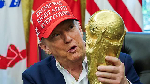 U.S. President Donald Trump wears a 'Trump Was Right About Everything!' hat while holding the FIFA World Cup Trophy, as he makes an announcement on the 2026 FIFA World Cup, in the Oval Office at the White House in Washington, D.C., U.S., August 22, 2025. REUTERS/Jonathan Ernst/File Photo