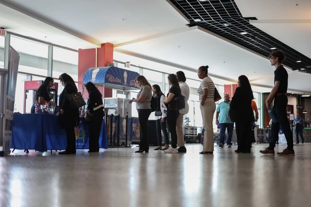 Job seekers wait to speak with a recruiter for Margaritaville Beach Resort, during the Mega JobNewsUSA South Florida Job Fair in September 2025. 