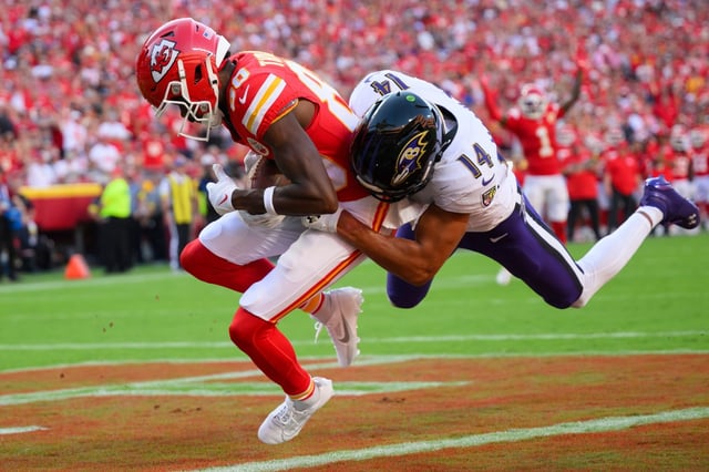 Kansas City Chiefs wide receiver Tyquan Thornton (80) scores a touchdown while being tackled by Baltimore Ravens safety Kyle Hamilton (14) during the second half of an NFL football game, Sunday, Sept. 28, 2025 in Kansas City, Mo. (AP Photo/Reed Hoffmann)