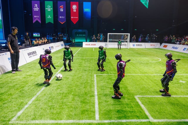 Robot players compete in the AI-powered robot football match in Beijing earlier this year.