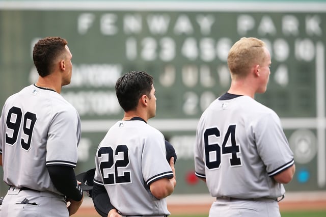 BOSTON, MA - JULY 14:  Aaron Judge #99, Jacoby Ellsbury #22 and Garrett Cooper #64 of the New York Yankees looks on before a game against the Boston Red Sox at Fenway Park on July 14, 2017 in Boston, Massachusetts.  (Photo by Adam Glanzman/Getty Images)