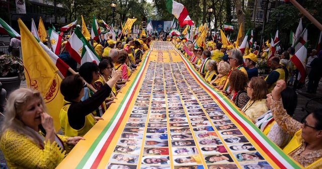 Activists carry a banner showing political prisoners executed by Iran in recent years, at a rally in New York. AP
