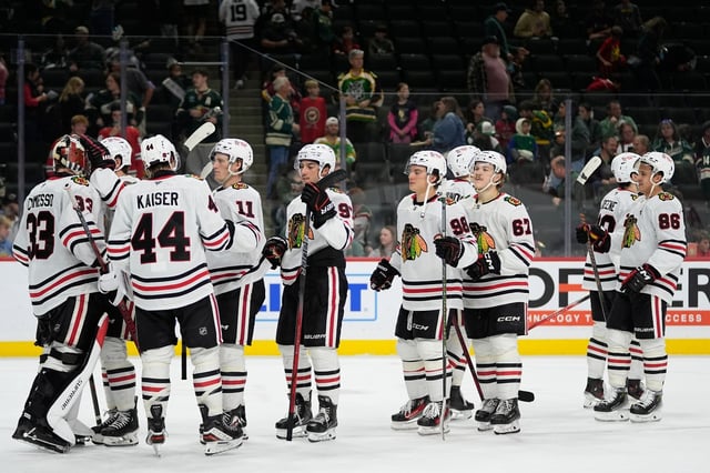 Chicago Blackhawks players celebrate after an NHL hockey preseason game against the Minnesota Wild, Sunday, Sept. 28, 2025, in St. Paul, Minn. (AP Photo/Abbie Parr)