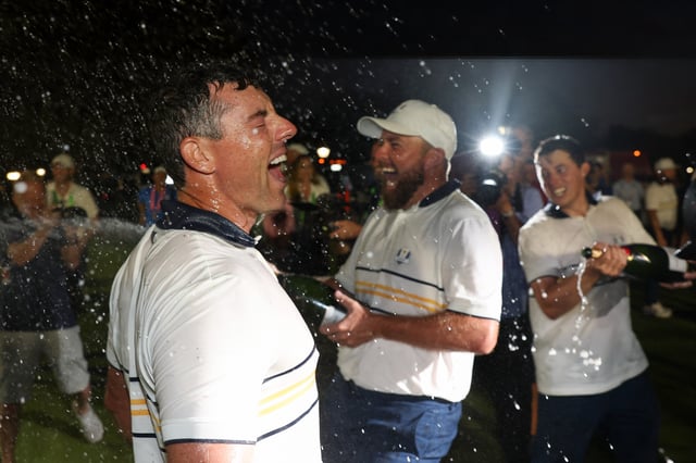 FARMINGDALE, NEW YORK - SEPTEMBER 28: Shane Lowry sprays Rory McIlroy of Team Europe with champagne after Europe secure victory during the Sunday singles matches of the 2025 Ryder Cup at Black Course at Bethpage State Park Golf Course on September 28, 2025 in Farmingdale, New York. (Photo by Richard Heathcote/Getty Images)