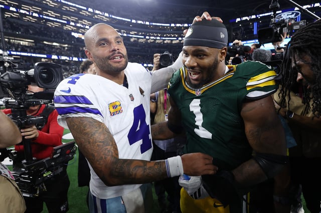 ARLINGTON, TEXAS - SEPTEMBER 28: Dak Prescott #4 of the Dallas Cowboys embraces Micah Parsons #1 of the Green Bay Packers after a tie game in overtime at AT&T Stadium on September 28, 2025 in Arlington, Texas. (Photo by Sam Hodde/Getty Images)