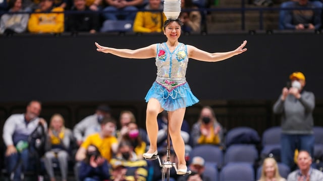 Jan 18, 2022; Morgantown, West Virginia, USA; Acrobat and performer Krystal Niu, known as Red Panda, performs at halftime at WVU Coliseum. Mandatory Credit: Ben Queen-Imagn Images