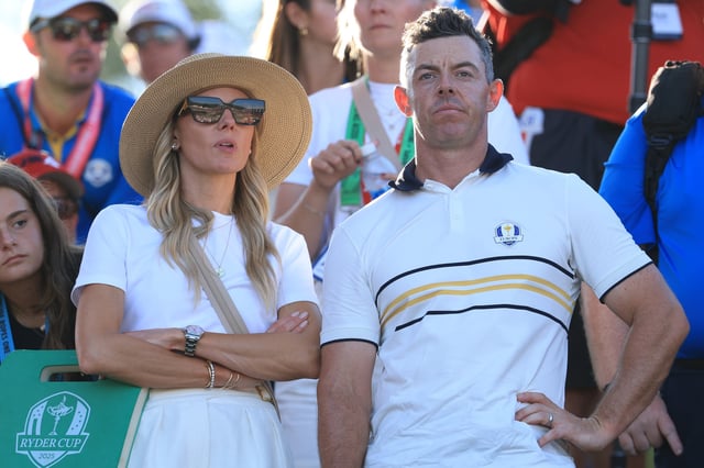 FARMINGDALE, NEW YORK - SEPTEMBER 28:   Rory McIlroy of Europe looks on with his wife Erica by the 17th green during the Sunday singles matches of the 2025 Ryder Cup at Black Course at Bethpage State Park Golf Course on September 28, 2025 in Farmingdale, New York. (Photo by David Cannon/Getty Images)