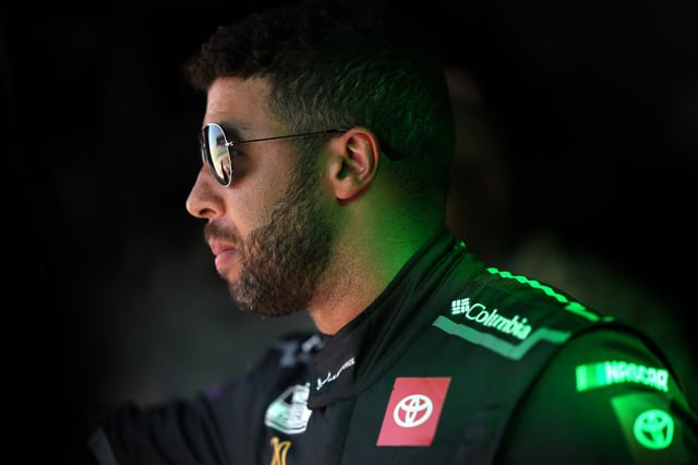 Bubba Wallace, driver of the #23 U.S. Air Force Toyota, waits backstage during pre-race ceremonies prior to the NASCAR Cup Series Hollywood Casino 400 Presented by ESPN BET at Kansas Speedway on September 28, 2025 in Kansas City, Kansas.