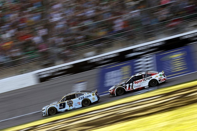 Chase Elliott, driver of the #9 Kelley Blue Book Chevrolet, and Denny Hamlin, driver of the #11 Sport Clips Haircuts Toyota, race during the NASCAR Cup Series Hollywood Casino 400 Presented by ESPN BET at Kansas Speedway on September 28, 2025 in Kansas City, Kansas.
