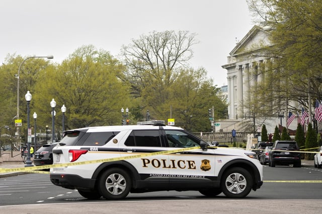 A police vehicle sits parked near the U.S. Treasury Department at right as the United States Secret Service tapes off a wide area around the White House, Thursday, April 3, 2025, in Washington, after early reports of a suspicious package and possible arrest. (AP Photo/Mark Schiefelbein)