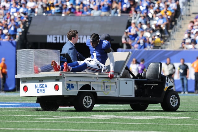 Sep 28, 2025; East Rutherford, New Jersey, USA;  New York Giants wide receiver Malik Nabers (1) is carted off the field following an injury during the second quarter against the Los Angeles Chargers at MetLife Stadium. Mandatory Credit: Brad Penner-Imagn Images