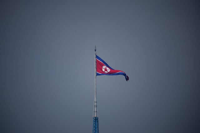 A North Korean flag flutters at the propaganda village of Gijungdong in North Korea, in this picture taken near the truce village of Panmunjom inside the demilitarized zone (DMZ) separating the two Koreas, South Korea, July 19, 2022.    REUTERS/Kim Hong-Ji/Pool/File Photo
