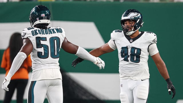 Aug 22, 2025; East Rutherford, New Jersey, USA; Philadelphia Eagles linebacker Patrick Johnson (48) celebrates a sack with defensive end Ogbo Okoronkwo (50) during the first half against the New York Jets at MetLife Stadium. Mandatory Credit: Vincent Carchietta-Imagn Images