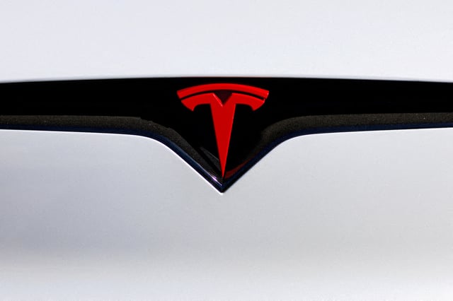 A logo is pictured on an electric car at the Tesla Inc. vehicle facility in Costa Mesa, California, U.S., November 1, 2023. REUTERS/Mike Blake/File Photo