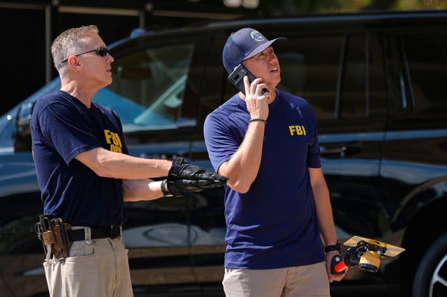 FBI agents investigate the crime scene near a U.S. Immigration and Customs Enforcement (ICE) office Thursday, Sept. 25, 2025, in Dallas. (AP Photo/Tony Gutierrez)