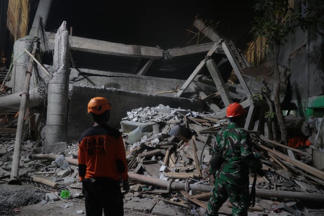 Rescuers search for survivors after a building collapsed at an Islamic boarding school, in Sidoarjo, East Java, Indonesia, Monday, Sept. 29, 2025. (AP Photo/Trisnadi)