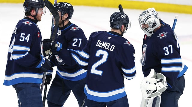 May 9, 2025; Winnipeg, Manitoba, CAN; Winnipeg Jets defenseman Dylan Samberg (54), Winnipeg Jets left wing Nikolaj Ehlers (27), Winnipeg Jets defenseman Dylan DeMelo (2) and Winnipeg Jets goaltender Connor Hellebuyck (37) celebrate their victory over the Dallas Stars in game two of the second round of the 2025 Stanley Cup Playoffs at Canada Life Centre. Mandatory Credit: James Carey Lauder-Imagn Images