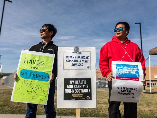  Postal workers picket in front of the Canada Post plant in Calgary on Sunday, Sept. 28, 2025.