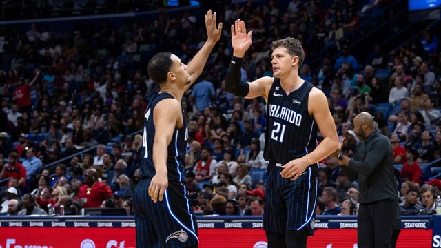 Feb 27, 2023; New Orleans, Louisiana, USA;  Orlando Magic center Moritz Wagner (21) congratulates guard Jalen Suggs (4) after a play against the New Orleans Pelicans during the second half at Smoothie King Center.