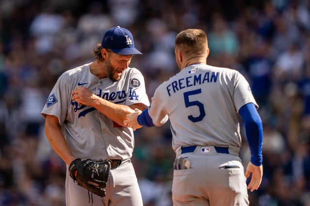 SEATTLE, WA - SEPTEMBER 28: Starting pitcher Clayton Kershaw #22 of the Los Angeles Dodgers jokes with Freddie Freeman #5 as he is pulled from a game against the Seattle Mariners in the sixth inning at T-Mobile Park on September 28, 2025 in Seattle, Washington. (Photo by Stephen Brashear/Getty Images)