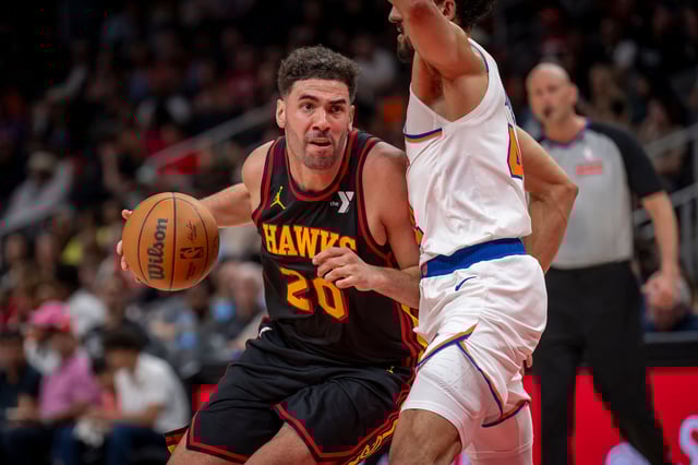 Atlanta Hawks forward Georges Niang, left, drives the ball down court against New York Knicks guard Landry Shamet (44), right, during the second half of an NBA basketball game, Saturday, April 5, 2025, in Atlanta. (AP Photo/Erik Rank)