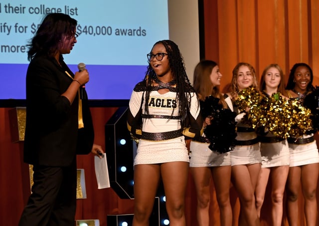 Joi Jones, College Board K-12 strategic account manager, congratulates senior Zhane Wiggins after she was awarded a $40,000 scholarship from the College Board. Representatives from the College Board visited Northeast High School in Pasadena to surprise a senior student with a $40,000 college scholarship. (Jeffrey F. Bill/Staff)