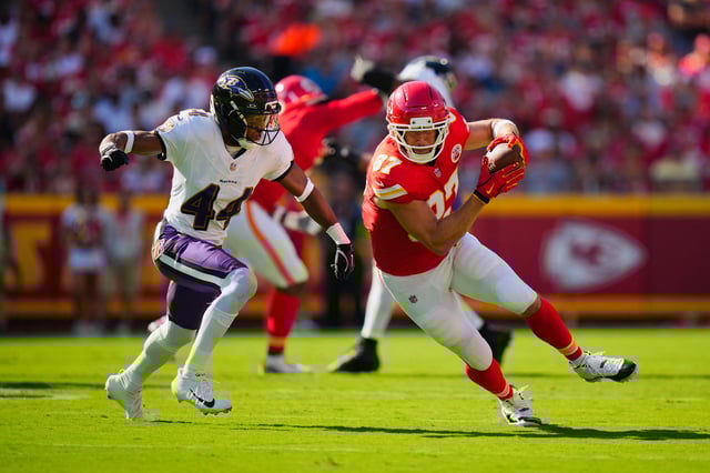 Sep 28, 2025; Kansas City, Missouri, USA; Kansas City Chiefs tight end Travis Kelce (87) rushes as Baltimore Ravens cornerback Marlon Humphrey (44) defends during the first half at GEHA Field at Arrowhead Stadium. Mandatory Credit: Jay Biggerstaff-Imagn Images/ File Photo
