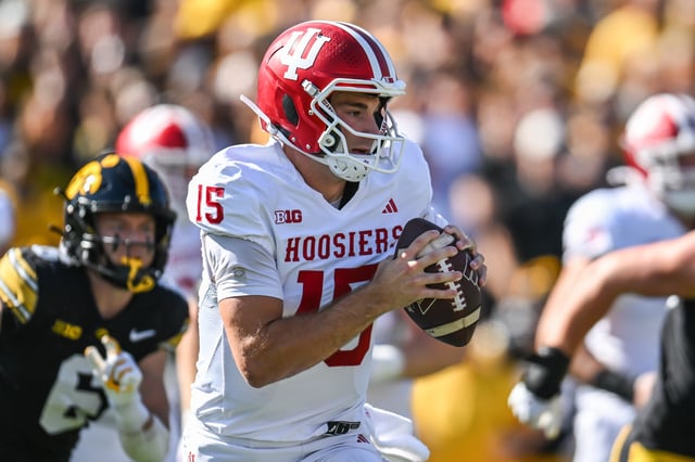 Sep 27, 2025; Iowa City, Iowa, USA; Indiana Hoosiers quarterback Fernando Mendoza (15) rolls out to throw a pass against the Iowa Hawkeyes during the first quarter at Kinnick Stadium. Mandatory Credit: Jeffrey Becker-Imagn Images/ File Photo