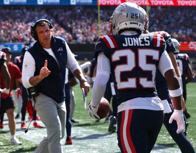 Foxboro, MA -New England Patriots head coach Mike Vrabel congratulates Marcus Jones after a punt return for a touchdown  during the first quarter of the game at Gillette Stadium. (Nancy Lane/Boston Herald)
