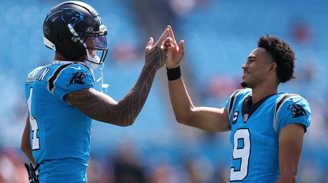 Sep 21, 2025; Charlotte, North Carolina, USA; Carolina Panthers quarterback Bryce Young (9) and wide receiver Tetairoa McMillan (4) high five before a game against the Carolina Panthers at Bank of America Stadium. Mandatory Credit: Cory Knowlton-Imagn Images