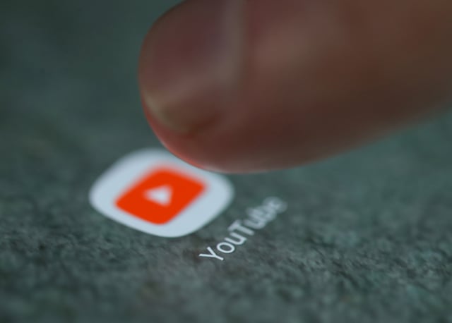 The YouTube app logo is seen on a smartphone in this picture illustration taken September 15, 2017. REUTERS/Dado Ruvic/Illustration