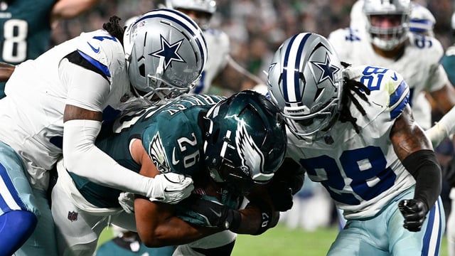 Philadelphia Eagles running back Saquon Barkley (26) carries the ball for a touchdown defended by Dallas Cowboys cornerback Trevon Diggs (7) and safety Malik Hooker (28) during the second quarter of the game at Lincoln Financial Field. Mandatory Credit: Eric Hartline-Imagn Images
