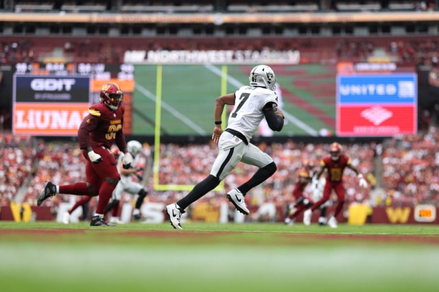 Sep 21, 2025; Landover, Maryland, USA; Las Vegas Raiders quarterback Geno Smith (7) scrambles from Washington Commanders defensive end Javontae Jean-Baptiste (90) during the fourth quarter at Northwest Stadium. Mandatory Credit: Geoff Burke-Imagn Images/ File Photo