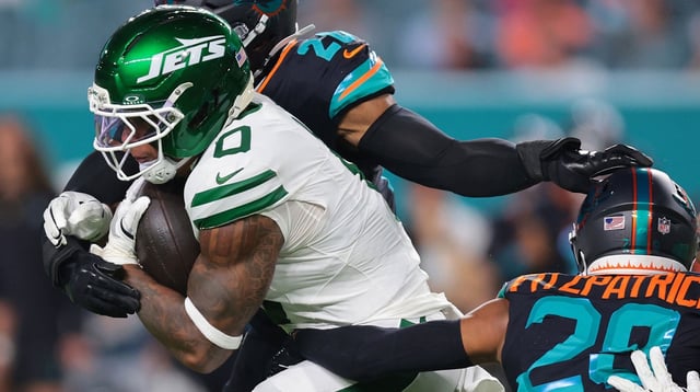 Sep 29, 2025; Miami Gardens, Florida, USA; New York Jets running back Braelon Allen (0) rushes the ball against Miami Dolphins defensive back Elijah Campbell (22) during the first half at Hard Rock Stadium. Mandatory Credit: Sam Navarro-Imagn Images